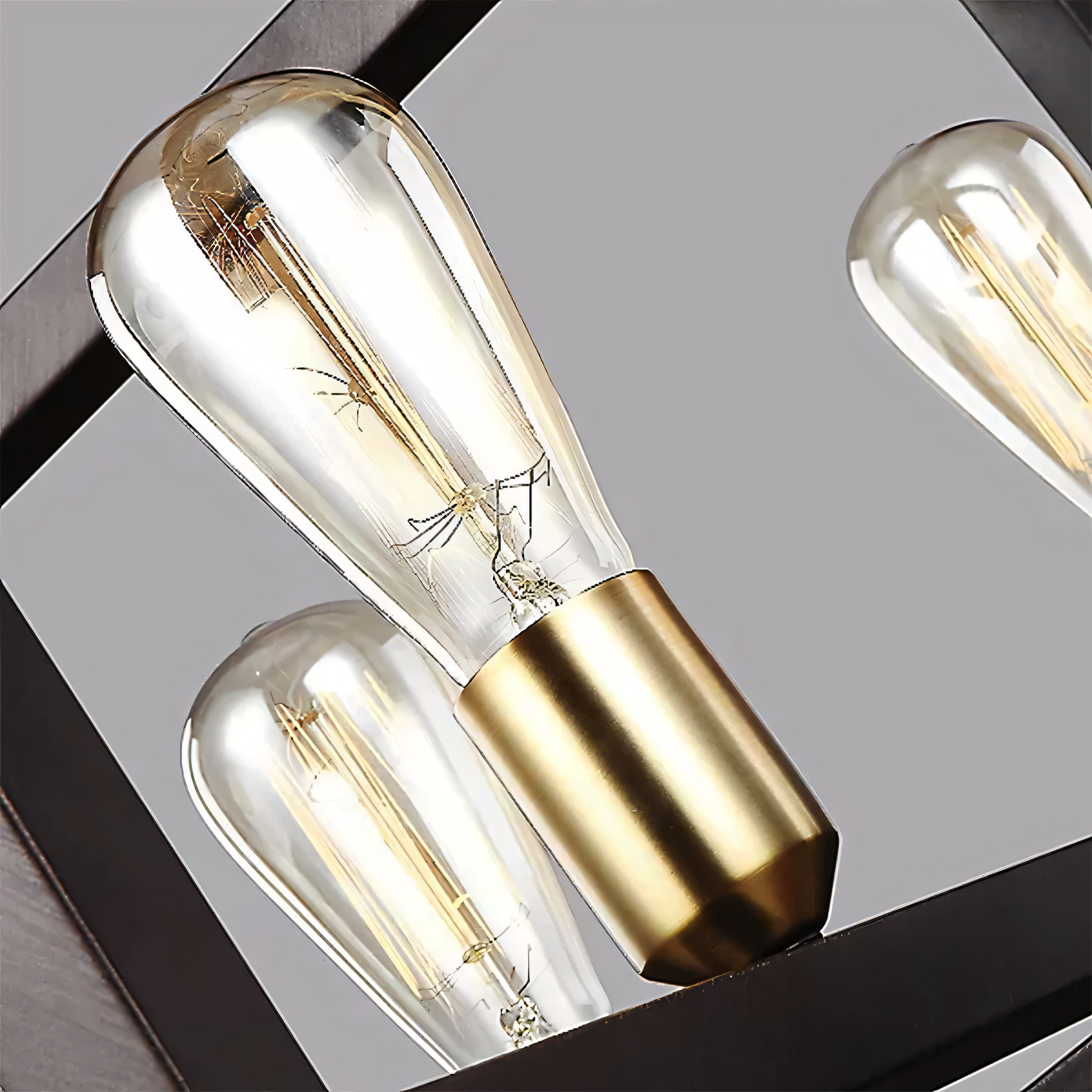The Simmetria Hanging Light's design features a rectangular bronze frame with two symmetrical arms holding clear glass globes.