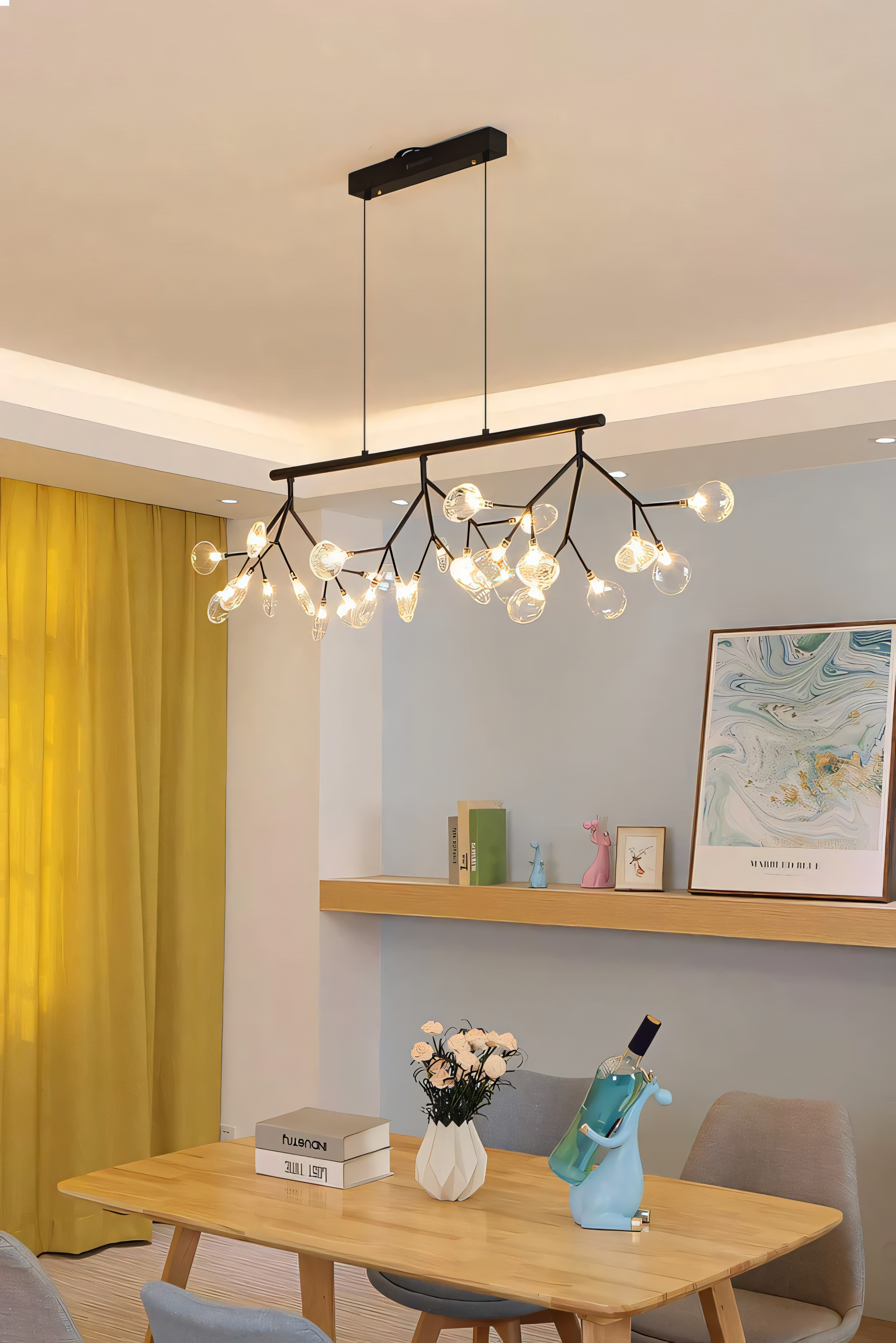The Blaze Modern Dining Chandelier adds a touch of rustic charm to a minimalist dining room. The chandelier's warm light fills the room.