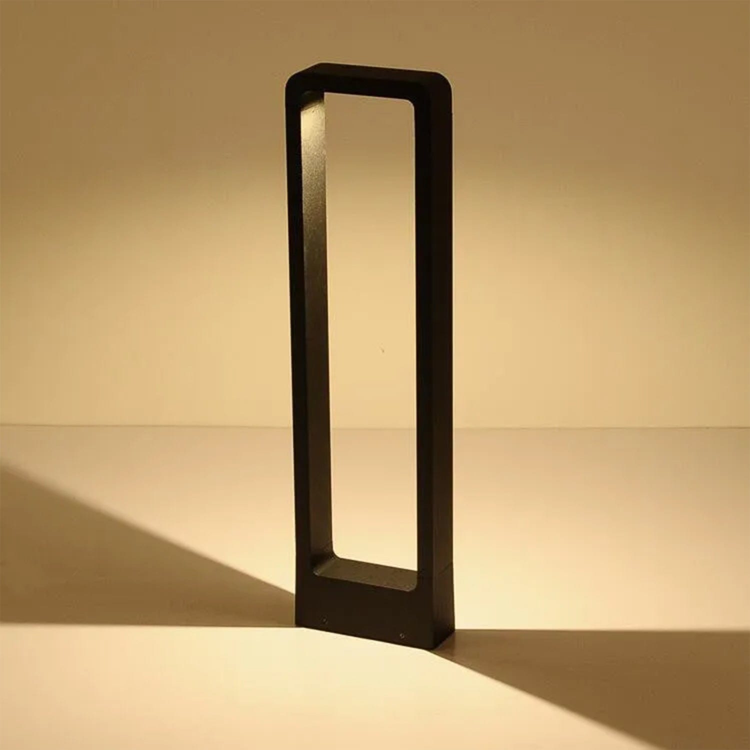 Elegant bollard light illuminating a garden pathway