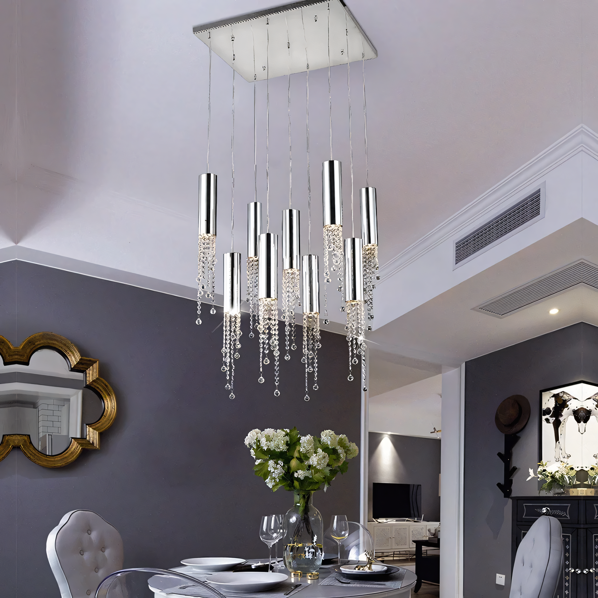 The Zooid Pendant Chandelier, a stunning centerpiece, hangs above a dining table.