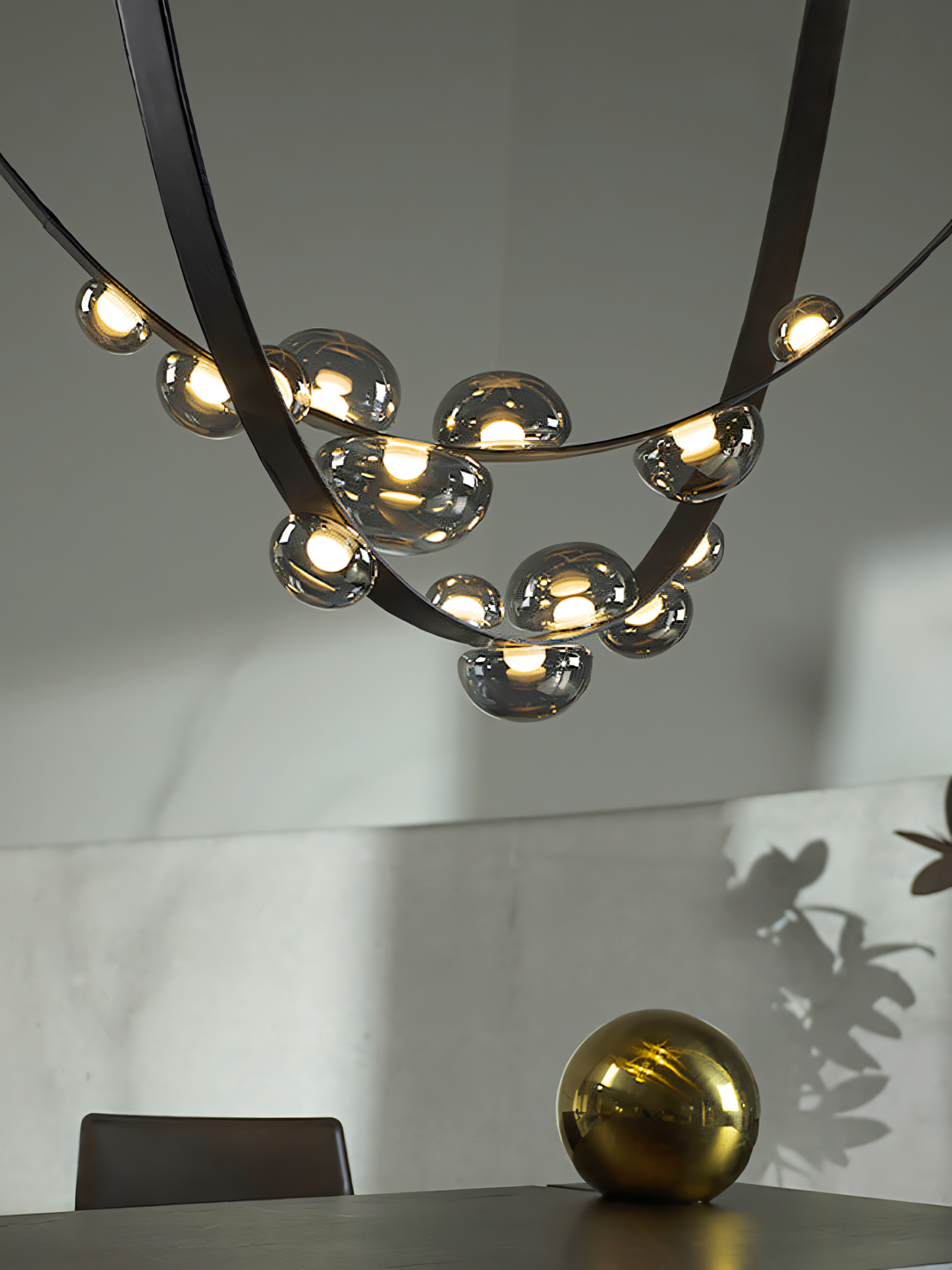 A close-up of the 7 Light 1500MM Black Leather Belt Black Smokey Glass Chandelier reveals the unique combination of black metal, textured leather, and smoky glass.