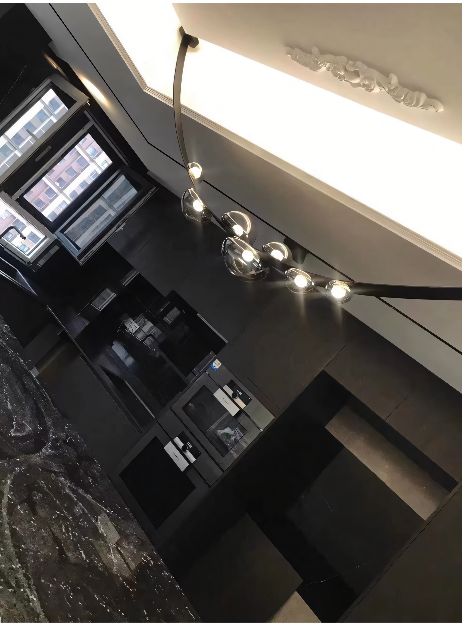 The 7 Light 1500MM Black Leather Belt Black Smokey Glass Chandelier adds a touch of rustic elegance to a modern dining room. The smoky glass globes cast a soft, diffused light.