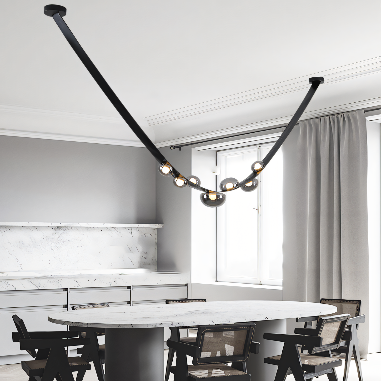 A black leather belt wraps around the central frame of this modern chandelier, suspending smoky glass globes that cast a warm glow on a dining table.