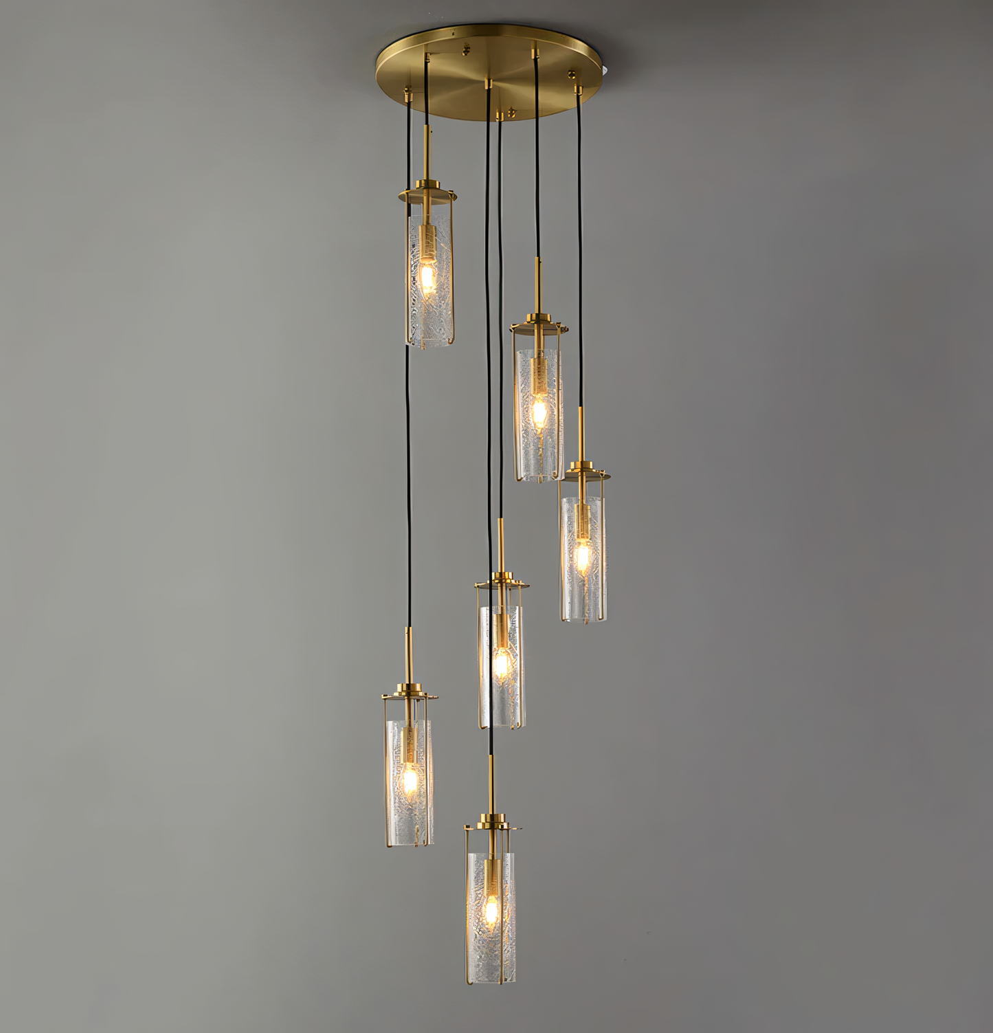 The 6 Light Brass Gold Crackle Glass Double Height Stair Chandelier features a brass frame with six individual arms adorned with hand-blown crackle glass globes.