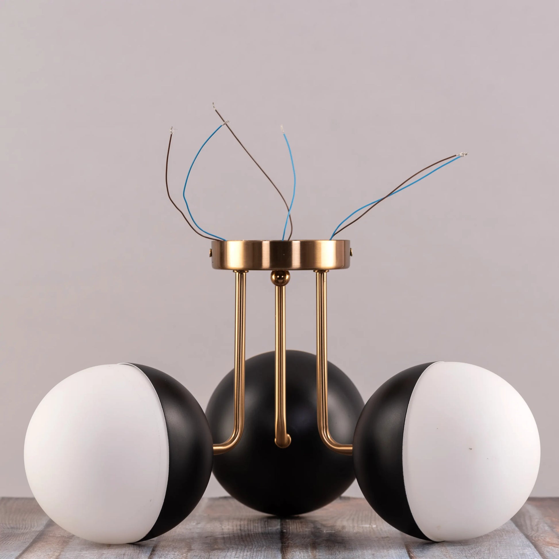 Dynamic ceiling light with gold and black color scheme.