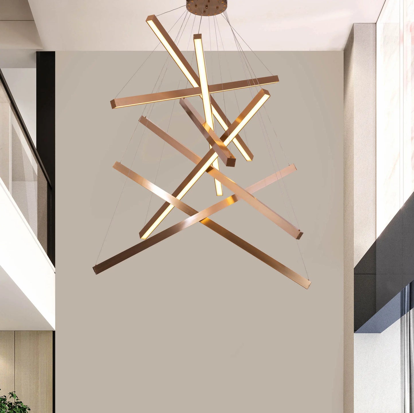 Large gold Toast To Tomorrow chandelier with double-height design illuminating a luxurious living room