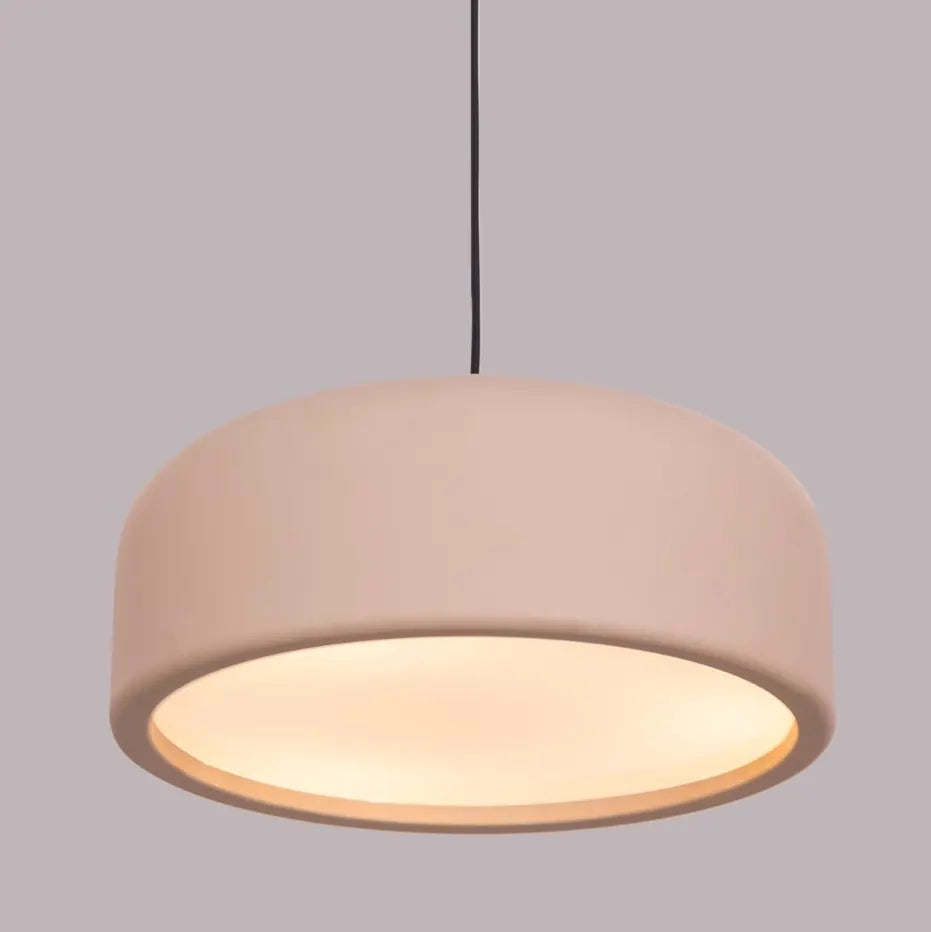 An artistic pendant light with a sleek, abstract design. It features a brushed brass metal frame, suspended by thin cables, with soft, warm light emitted through frosted glass diffusers. The light creates a modern, elegant ambiance, perfect for contemporary interiors.