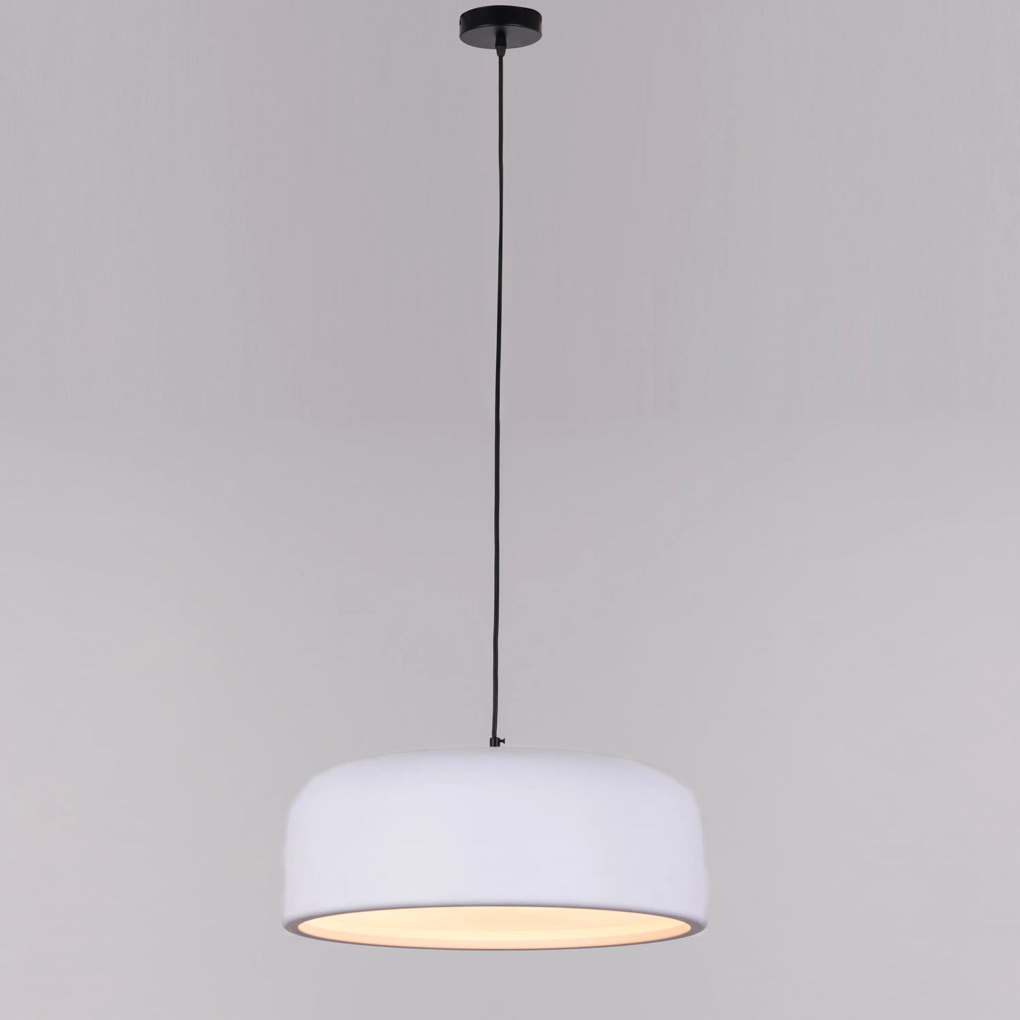 An artistic pendant light with a sleek, abstract design. It features a brushed brass metal frame, suspended by thin cables, with soft, warm light emitted through frosted glass diffusers. The light creates a modern, elegant ambiance, perfect for contemporary interiors.