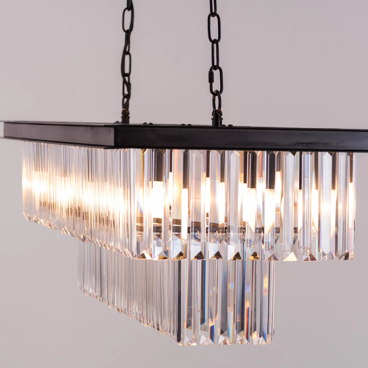 Trust Fund Baby crystal chandelier hanging in a luxurious grand foyer.