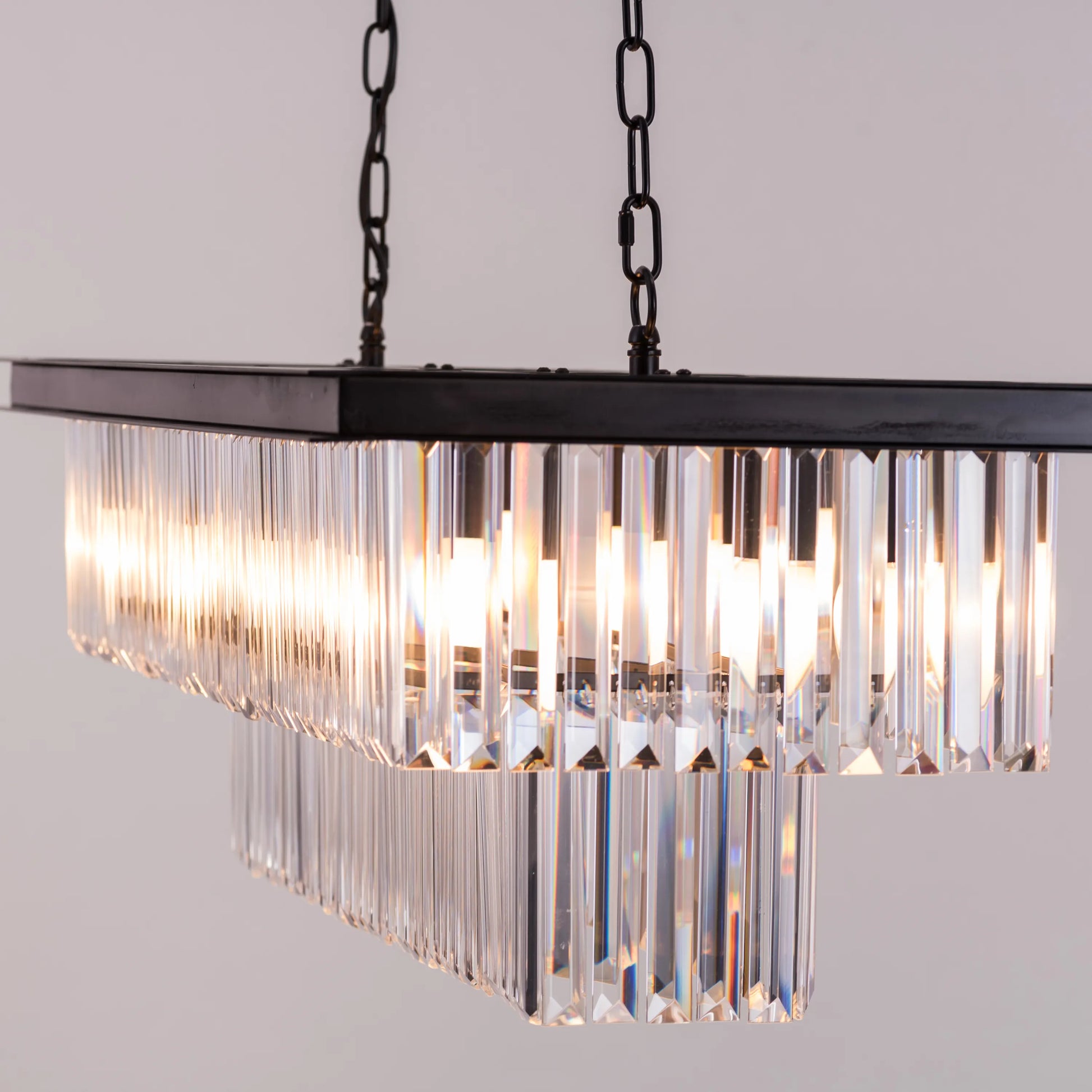 Trust Fund Baby crystal chandelier hanging in a luxurious grand foyer.