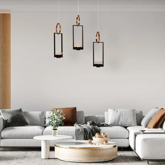 Adding Up Chandelier with sleek black and gold design illuminating a modern living room.