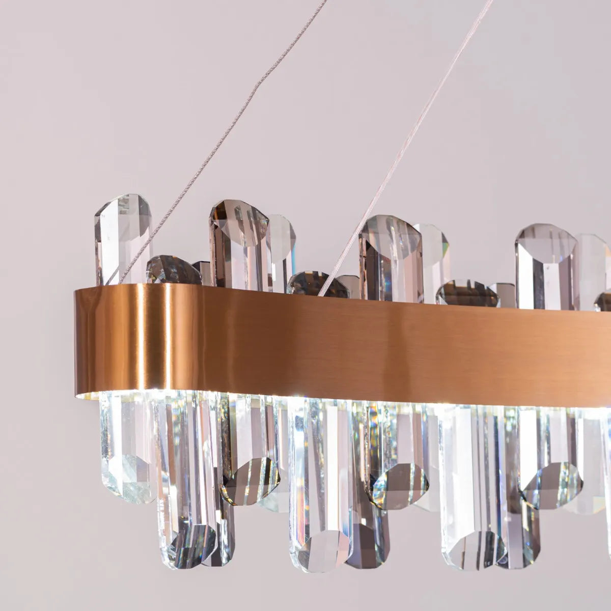 Start From Scratch long crystal chandelier illuminating a grand, open-concept living space