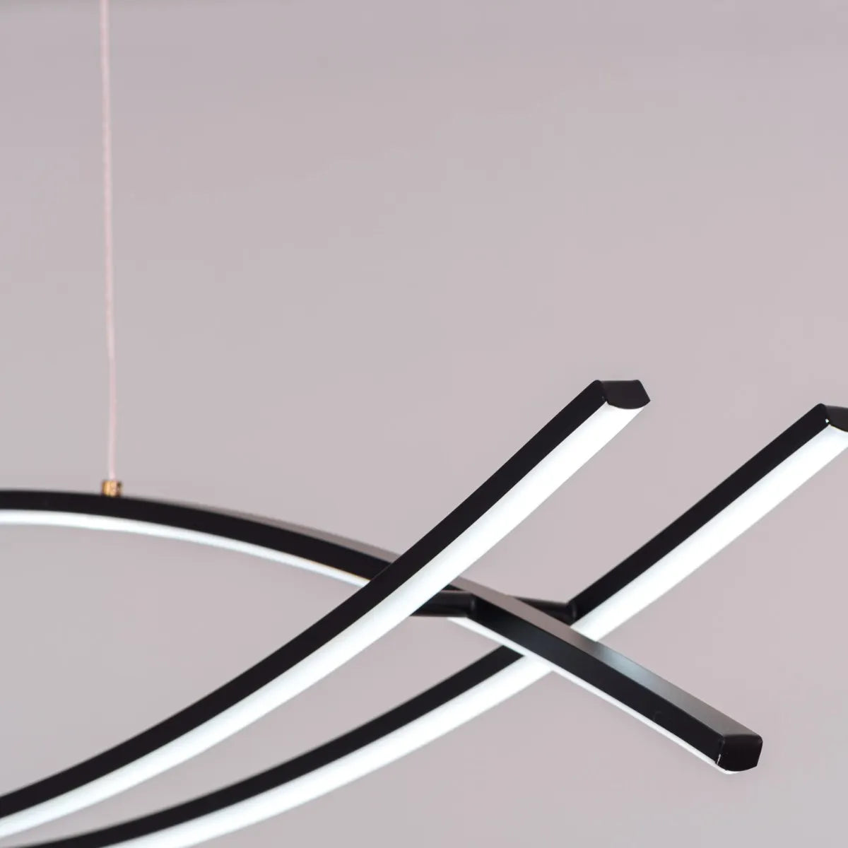 Believe In Me Chandelier suspended in a home office, its striking black elements contrasting with warm white light, creating an inspiring workspace.