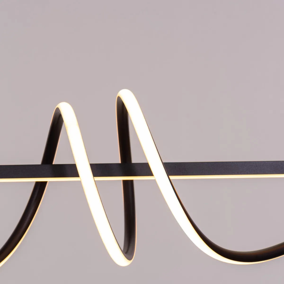 Up In The Air Chandelier suspended in a modern living room, its black elements contrasting dramatically with warm white light.