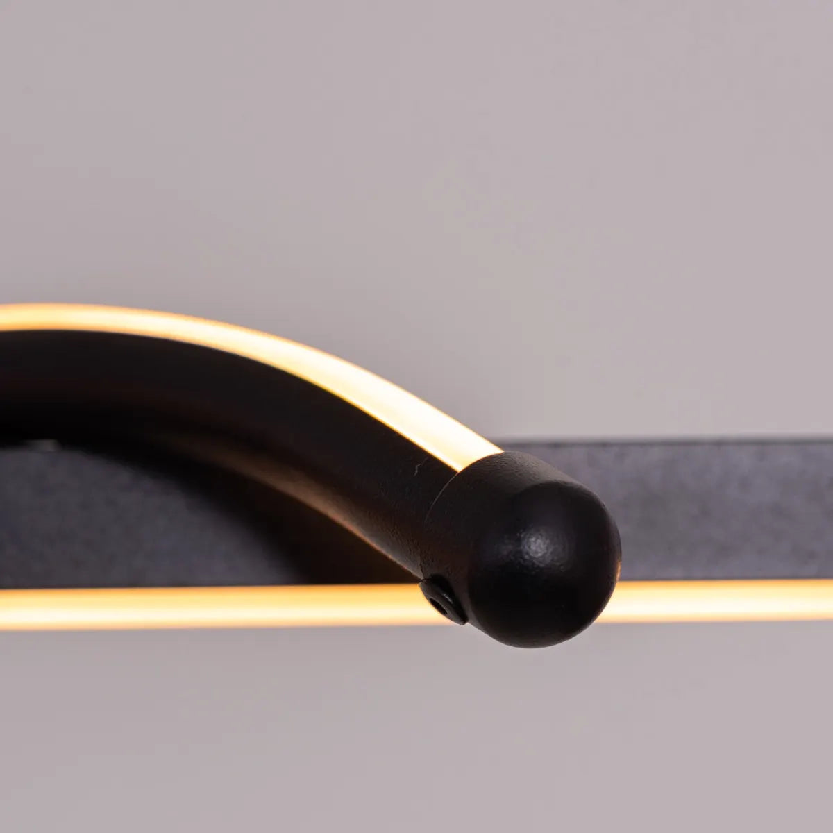 Up In The Air Chandelier suspended in a modern living room, its black elements contrasting dramatically with warm white light.