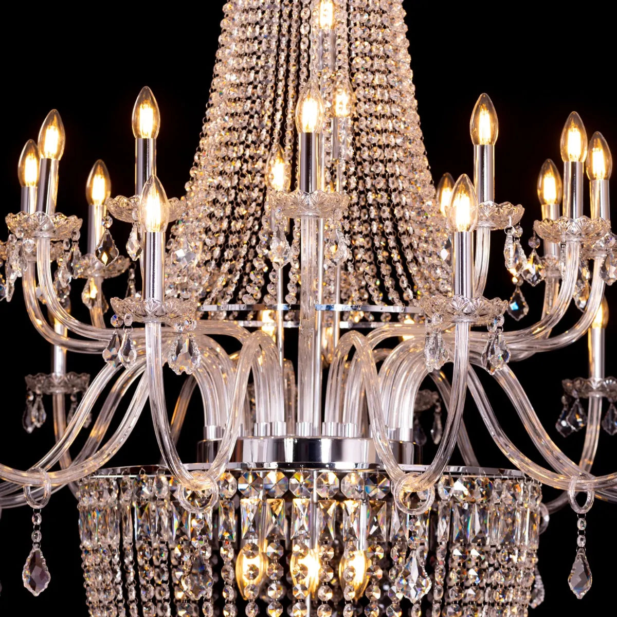 Large chrome crystal chandelier with letter-shaped elements, hanging in a luxurious living room