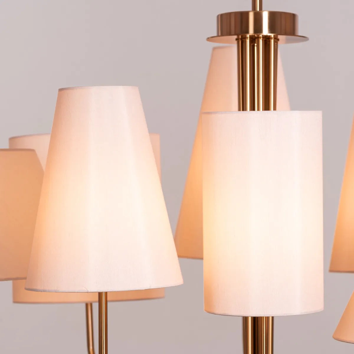 Large gold and beige fabric chandelier with layered shades resembling fluttering pages