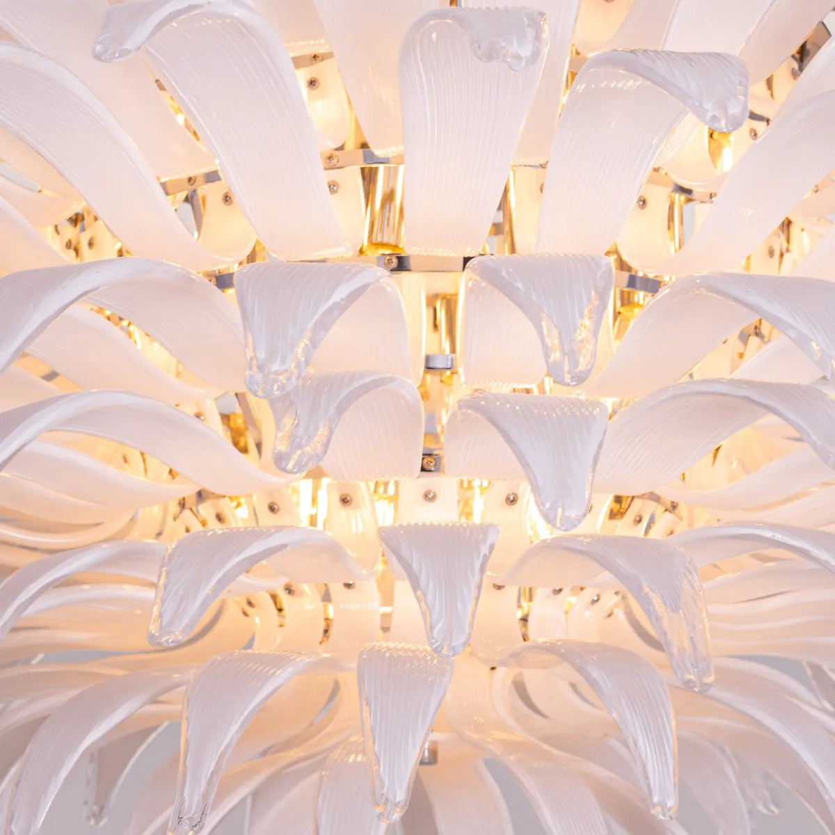 One More Try large chandelier with gold frame and white tinted glass panels illuminating a modern living room