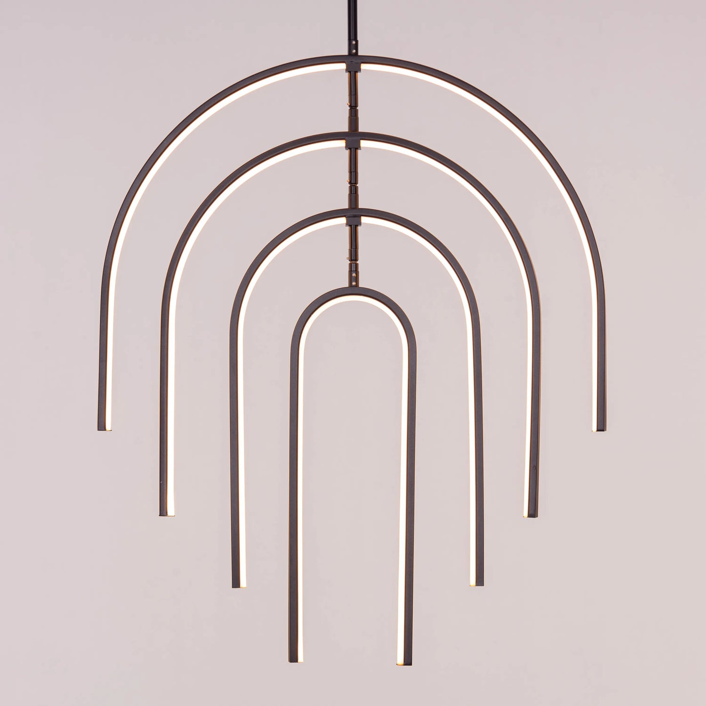 Heatwave Black Chandelier illuminating a room with vibrant amber light, showcasing its unique wave-inspired design