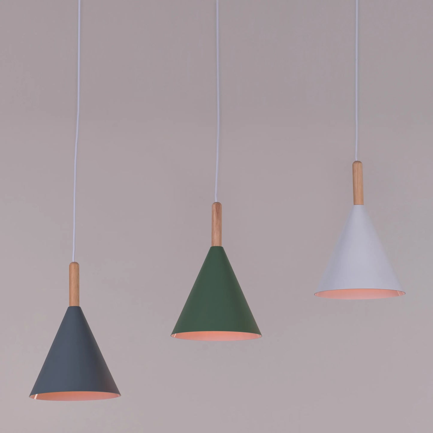 A vibrant pendant light named 'Bonus Points,' featuring three hanging heads in a playful combination of blue, green, and white. Each pendant has a smooth, minimalist design with sleek curves, creating a modern and cheerful aesthetic. The multi-colored arrangement adds a pop of color and a fun, dynamic vibe to any room.