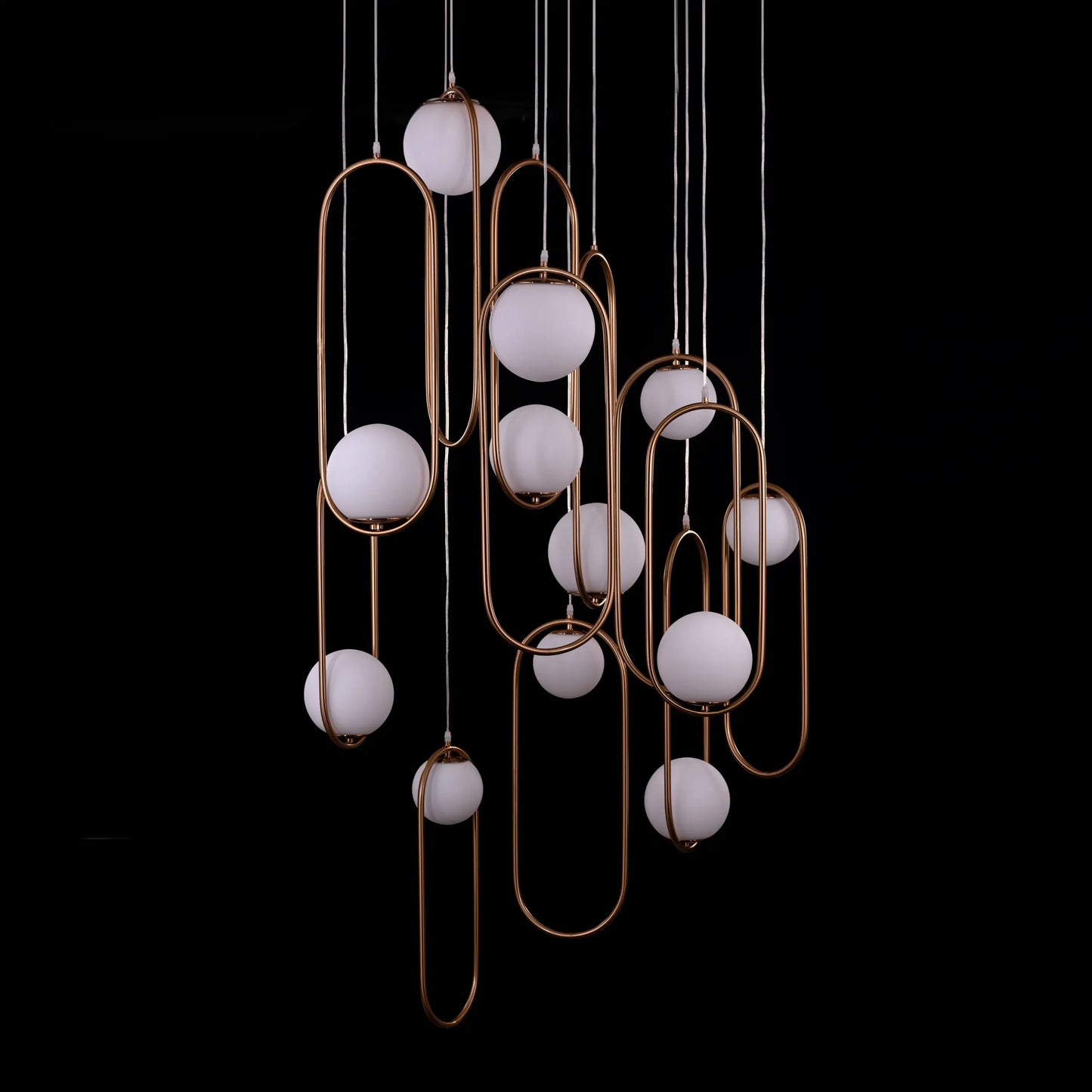 Large gold April In Paris chandelier with double-height design illuminating a luxurious Parisian-inspired living room