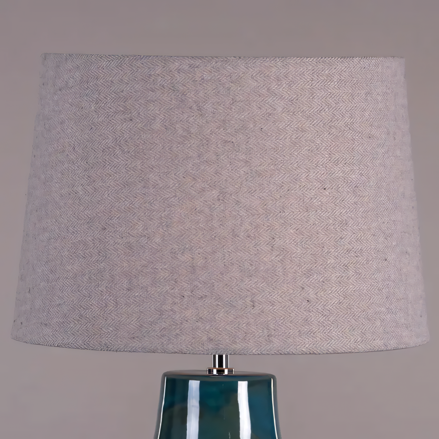 Soft blue fabric shade casting warm, tranquil light