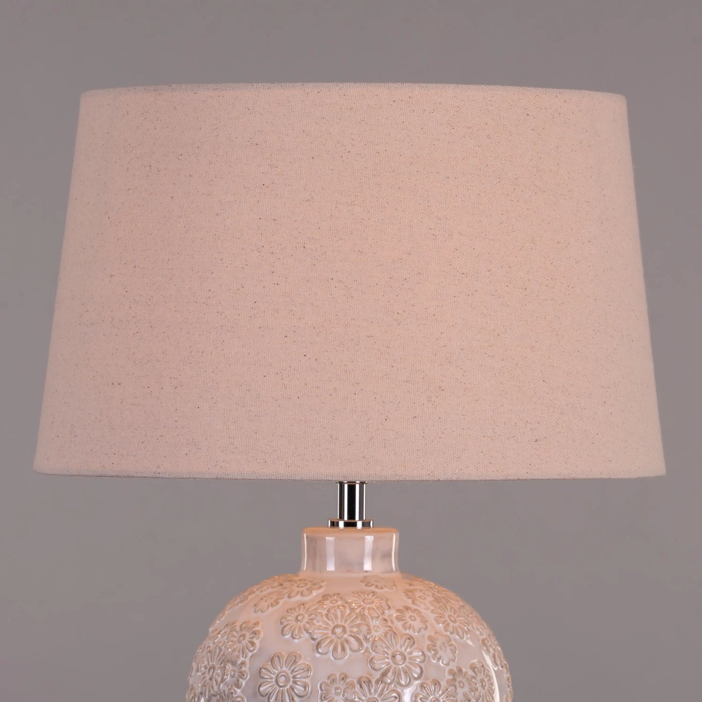 Warm and inviting ambiance from cream ceramic lamp