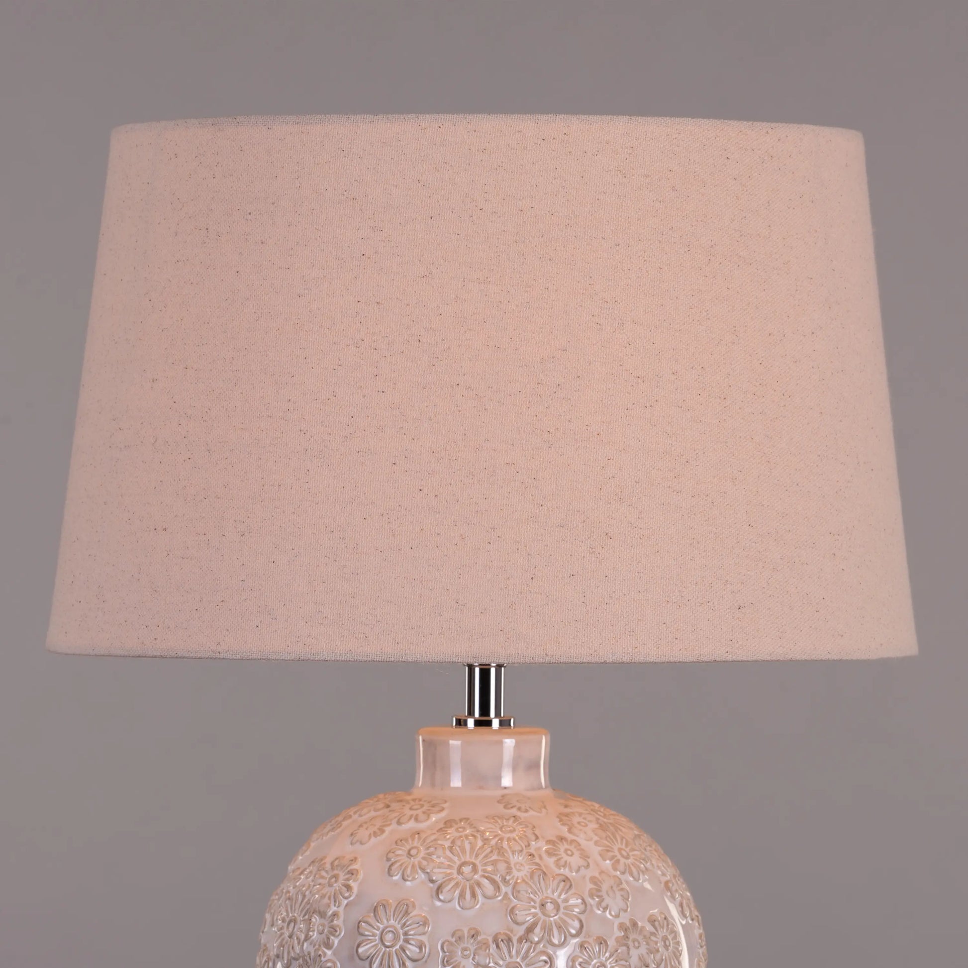 Warm and inviting ambiance from cream ceramic lamp