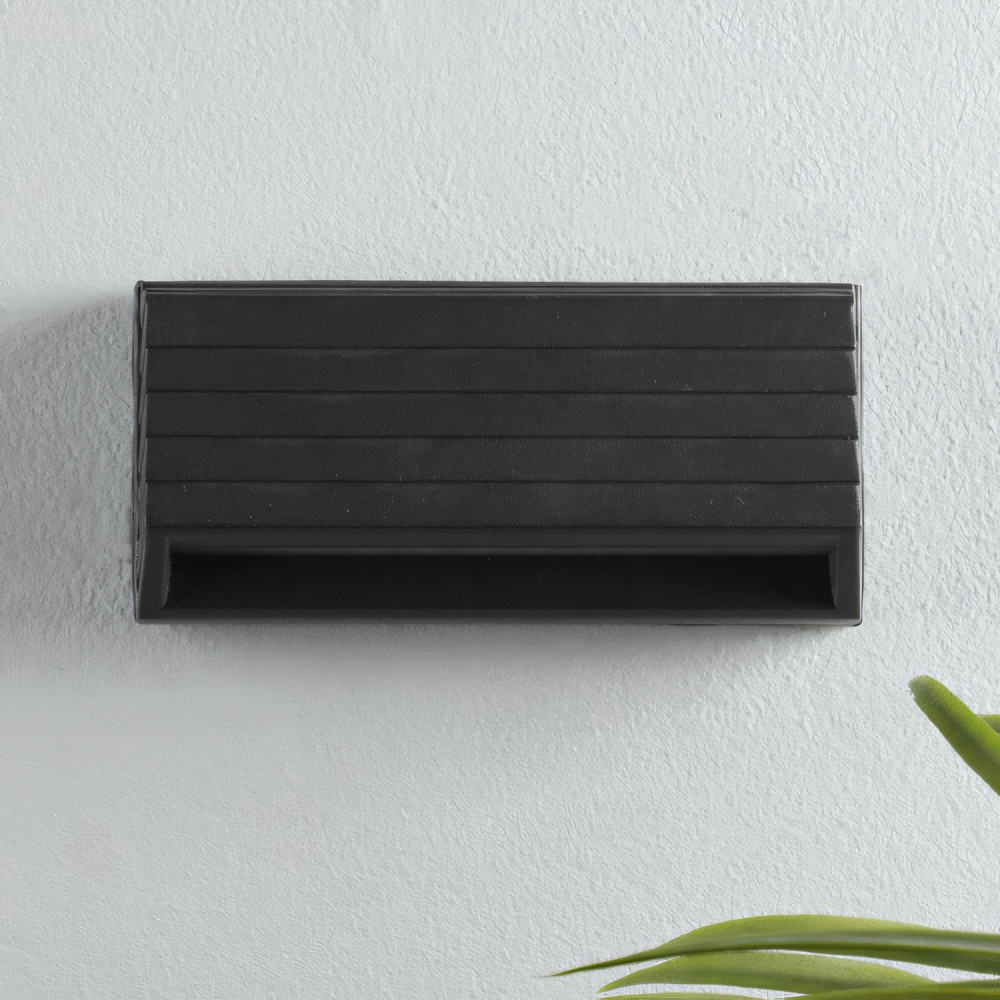 Black metal outdoor light with intricate designs