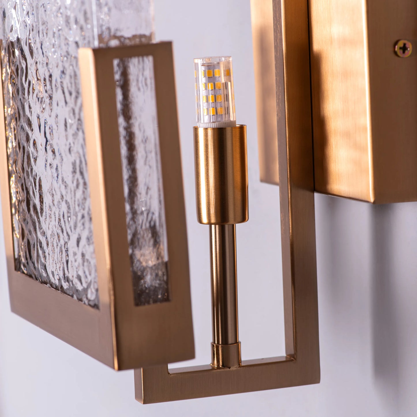 "Legacy Signature" Textured Glass Wall Light - A sleek, modern wall sconce with a textured glass shade that diffuses warm, glowing light.