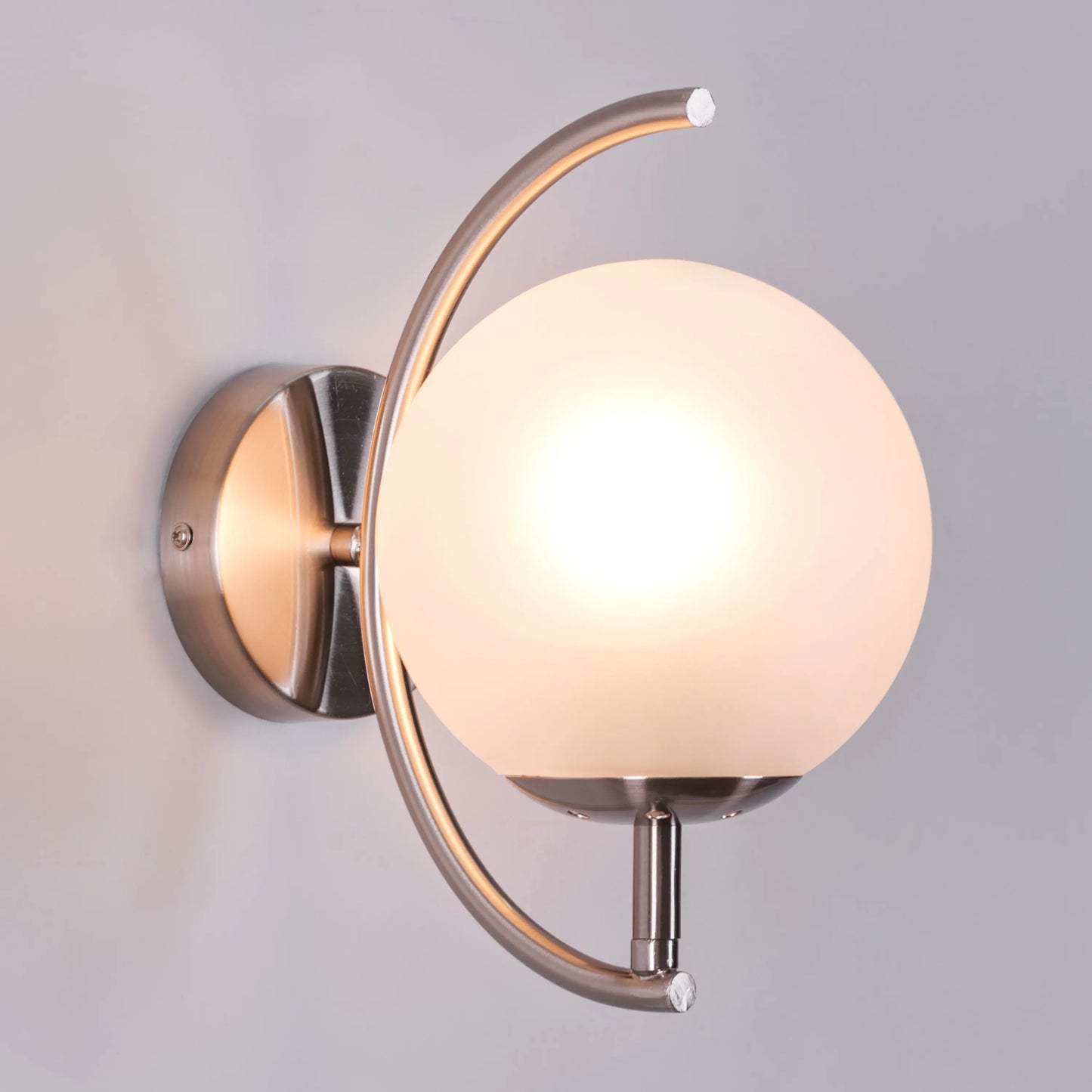 Show Me Love wall light casting a warm glow in a minimalist bedroom.