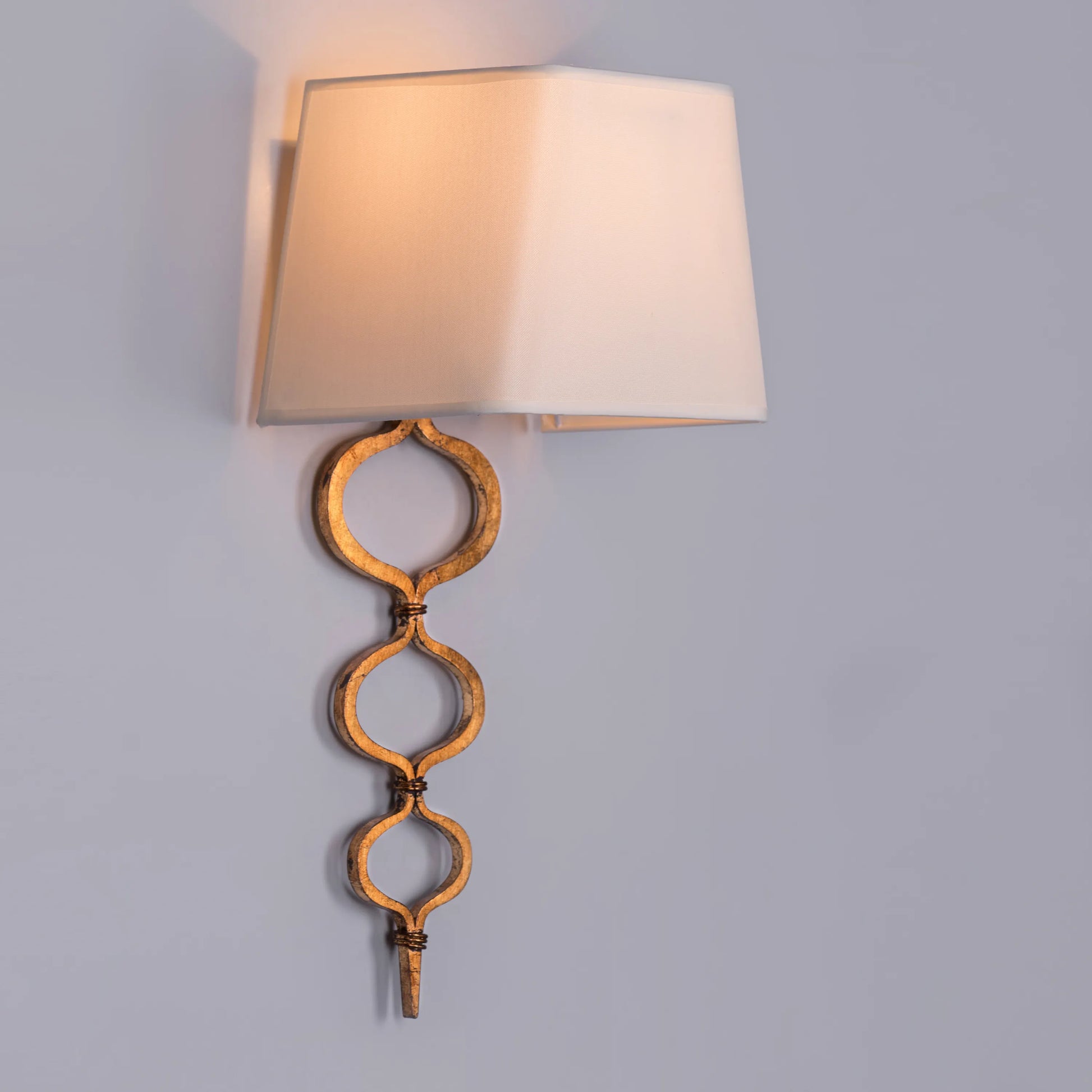 Elegant wall light with a warm, sunlit glow and gold finish; perfect for creating cozy ambiance in bedrooms and living areas.