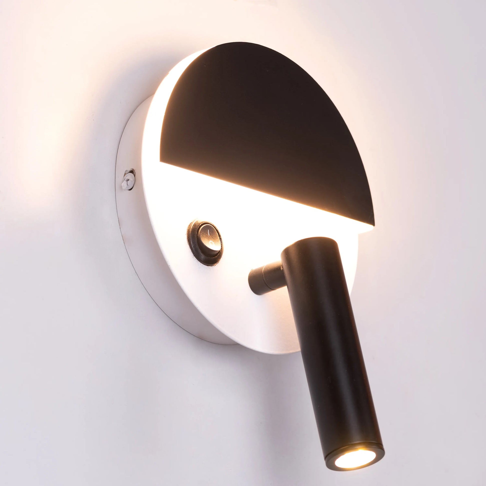 Elegant Elated Wall Light featuring a geometric layered design in brushed metal finish, projecting warm ambient light through crystal-clear glass elements against a neutral wall