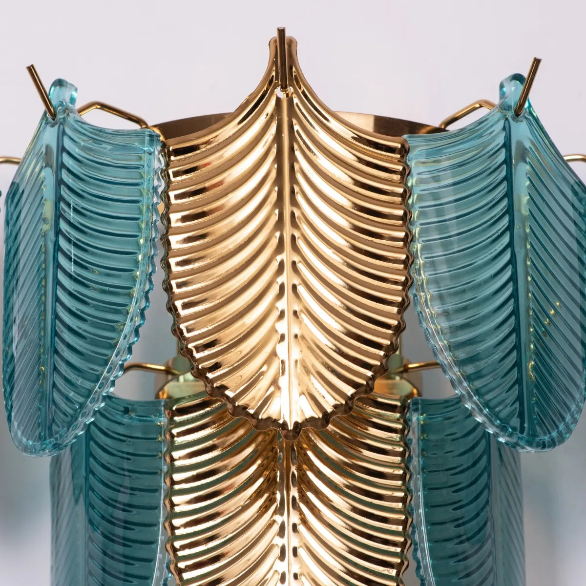 Magic In Milan glass wall light casting a warm glow in a modern living room.