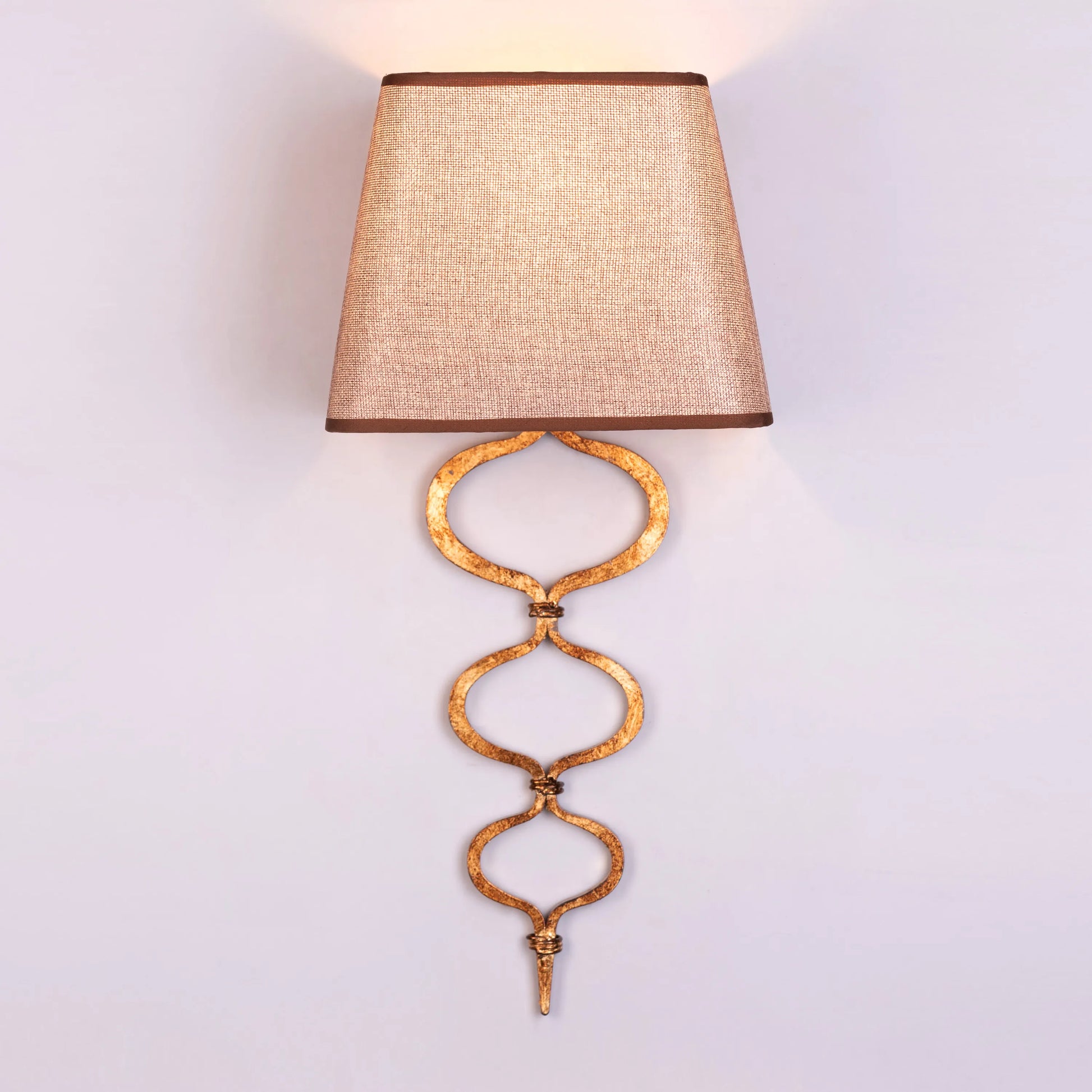 Elegant wall light with a warm, sunlit glow and gold finish; perfect for creating cozy ambiance in bedrooms and living areas.