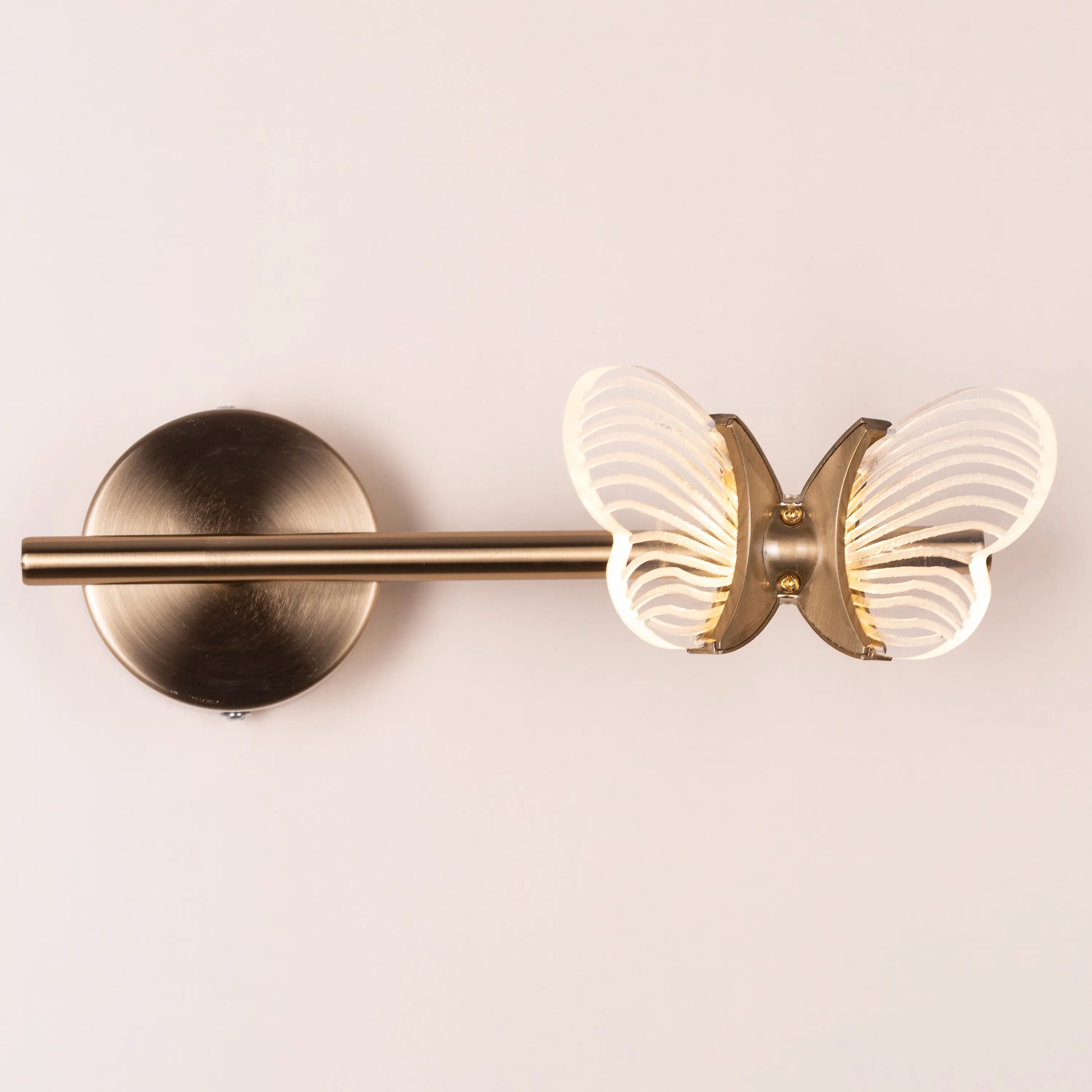 Butterfly Kisses Wall Light - Delicate and enchanting wall lighting fixture featuring a cluster of elegant metal cutouts that form the wings of a butterfly, creating a mesmerizing play of light and shadow.