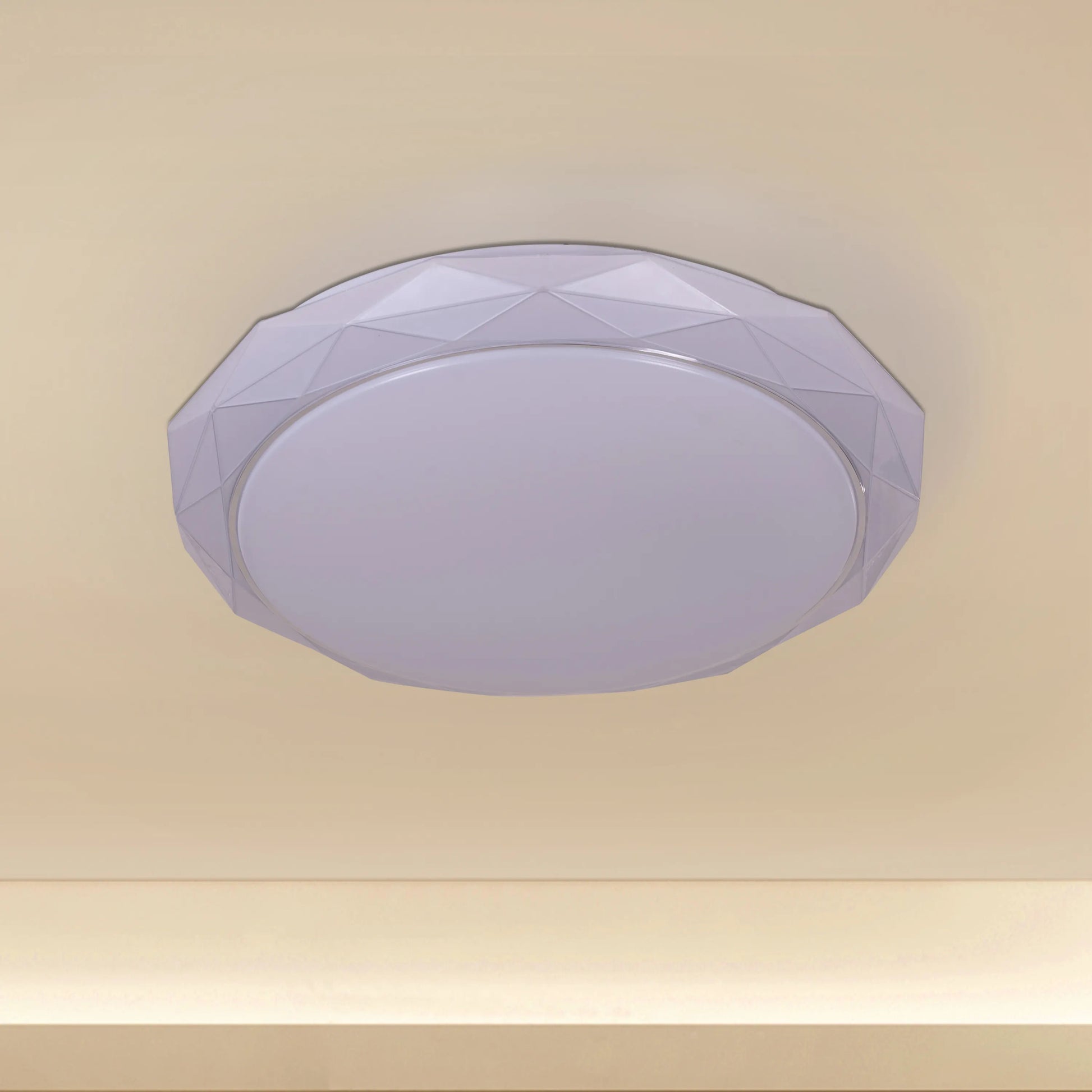 Chrome ceiling light with sleek design and built-in LED lights, displaying warm white illumination