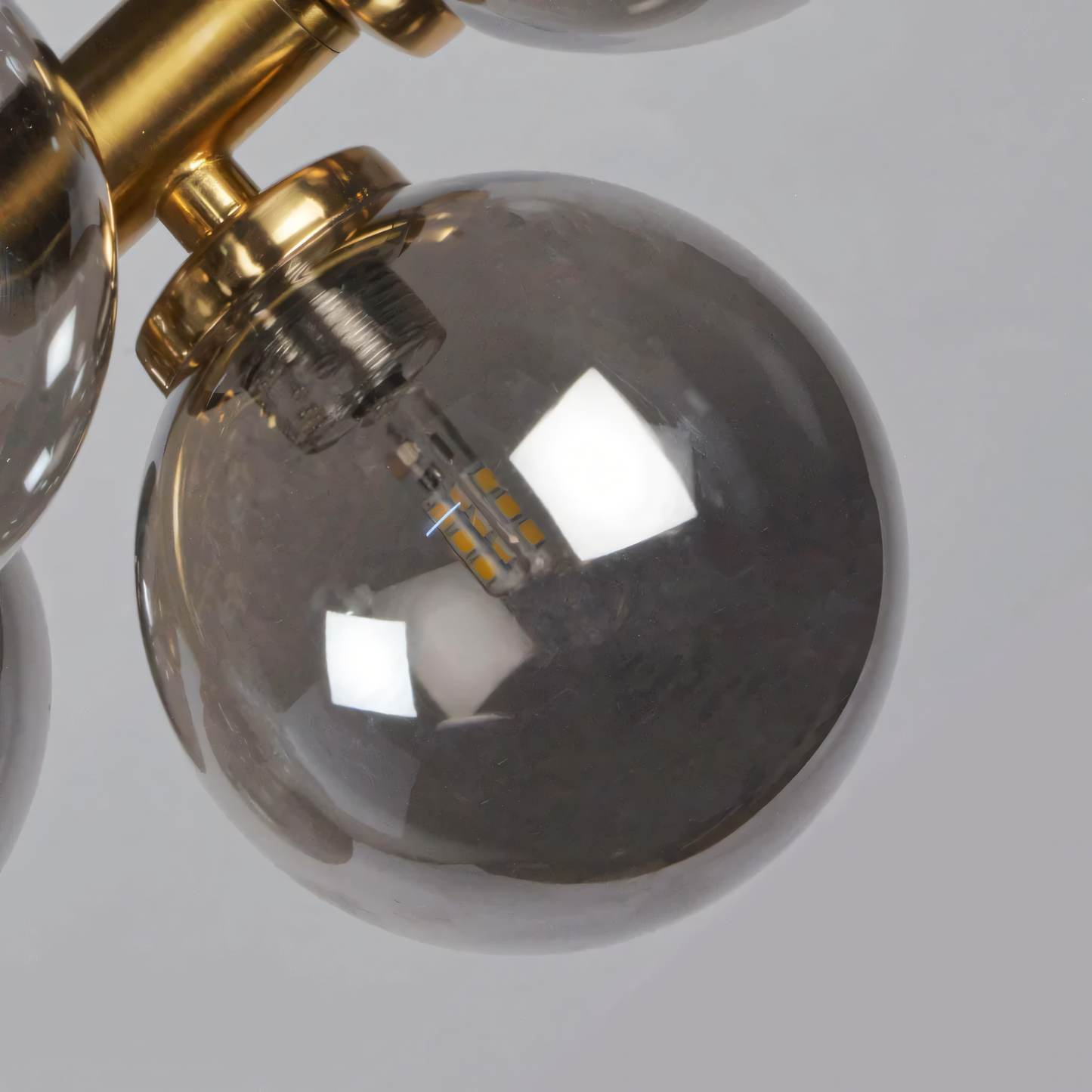 Sleek, black-finished metal frame of the Bellus Catuli Chandelier