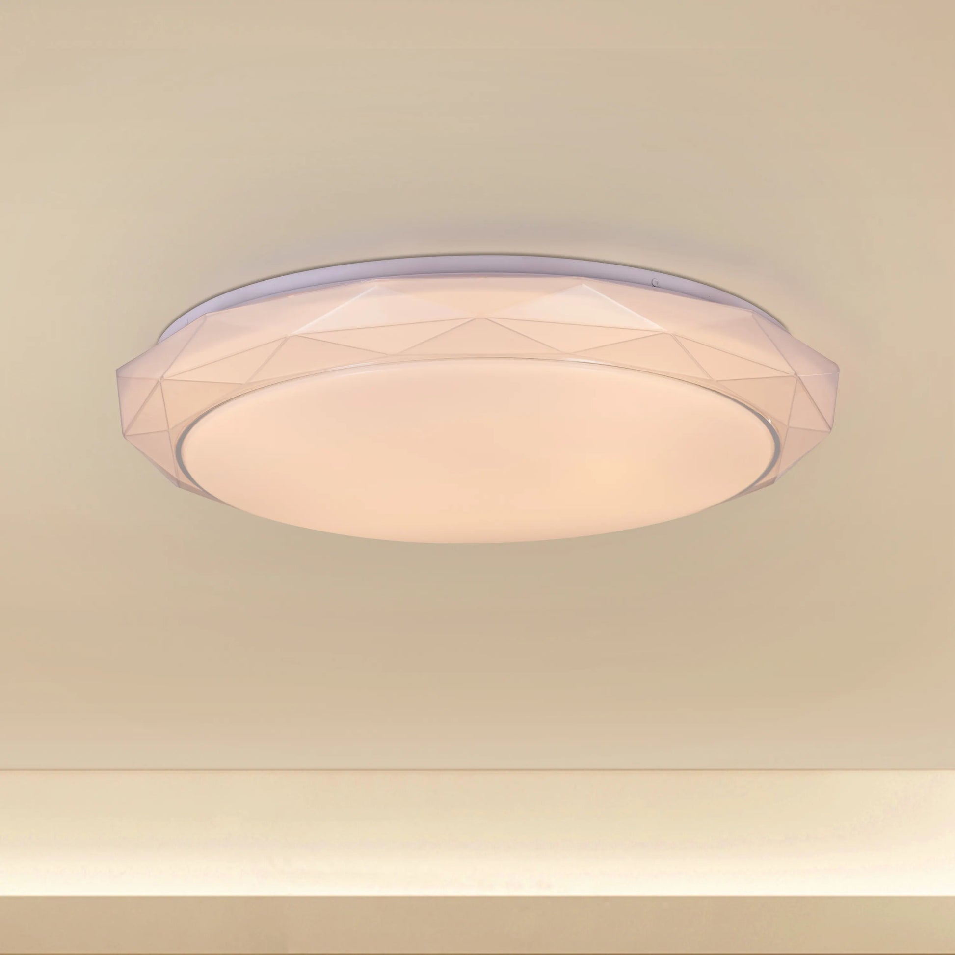 Chrome ceiling light with sleek design and built-in LED lights, displaying warm white illumination