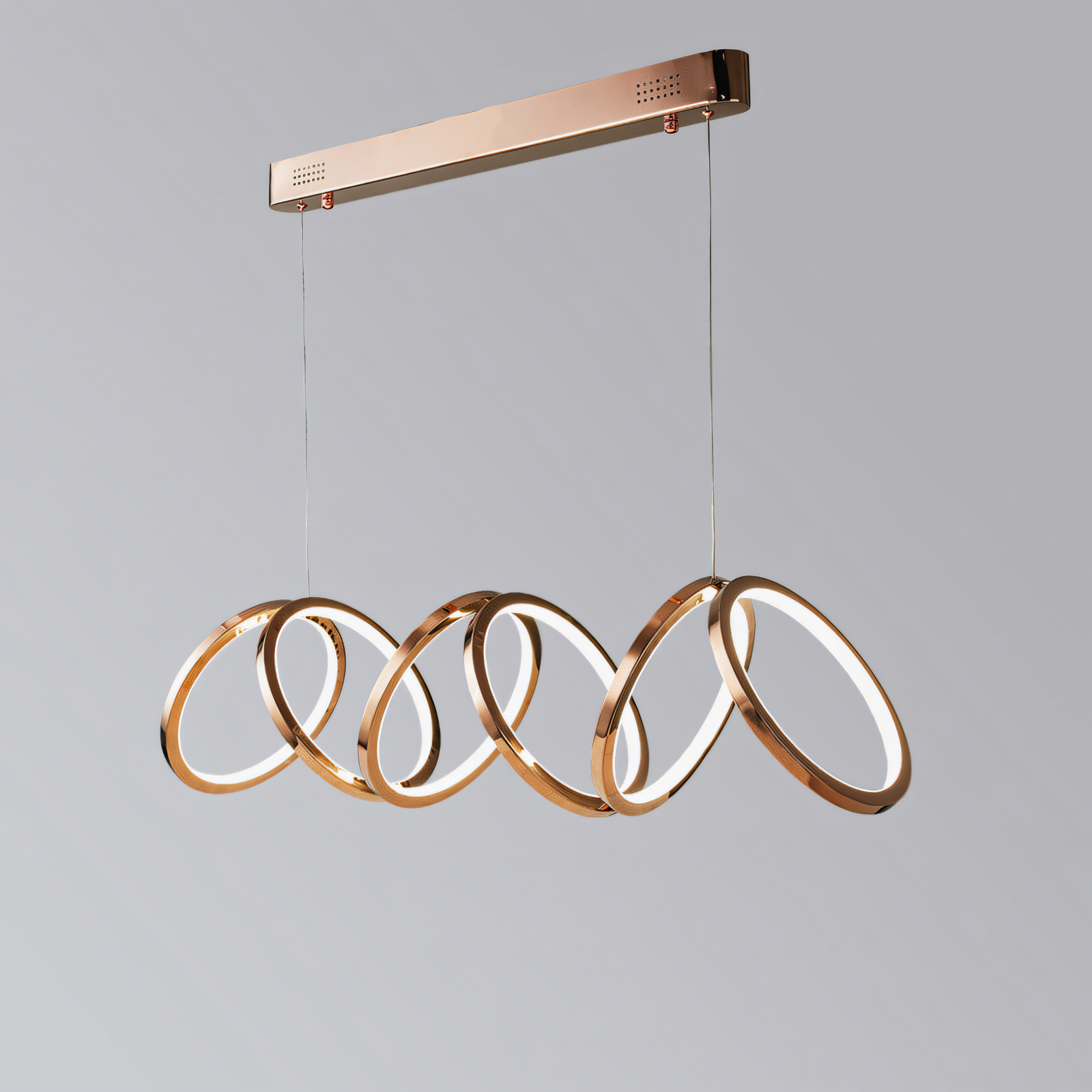 This modern rose gold chandelier features a cascading ring design, adding a touch of warmth and sophistication to your space.