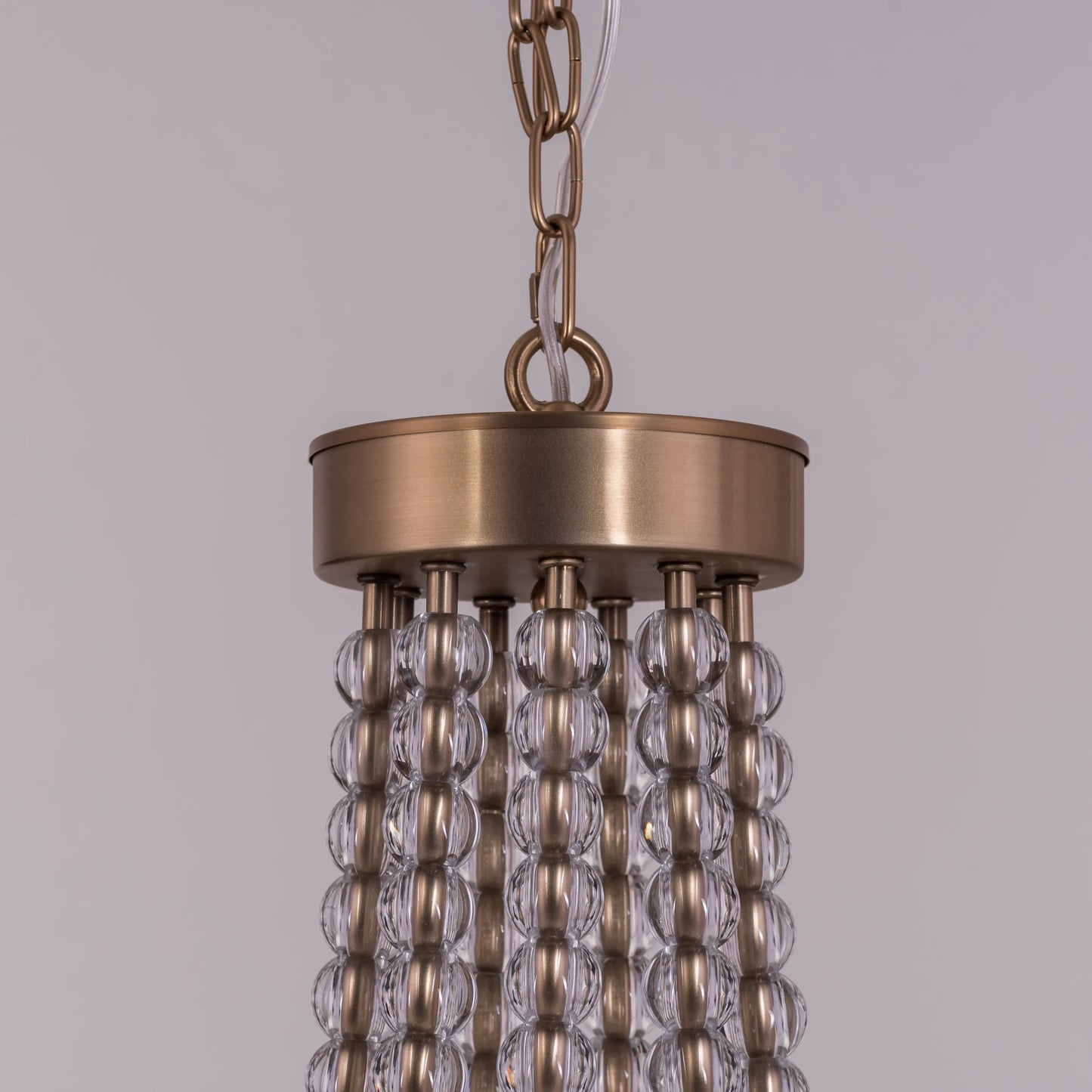 King's Gambit large gold crystal chandelier illuminating a grand entryway