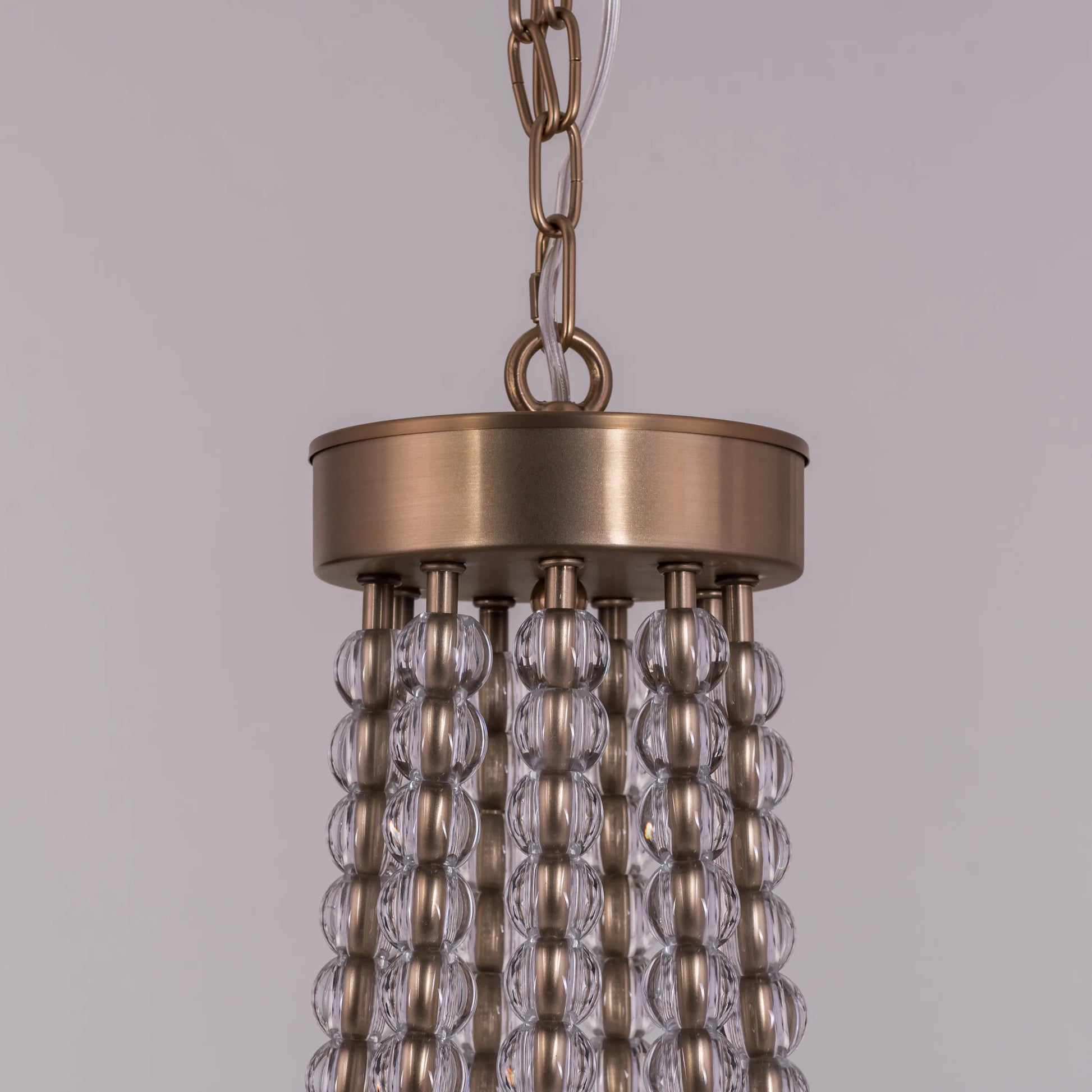 King's Gambit large gold crystal chandelier illuminating a grand entryway