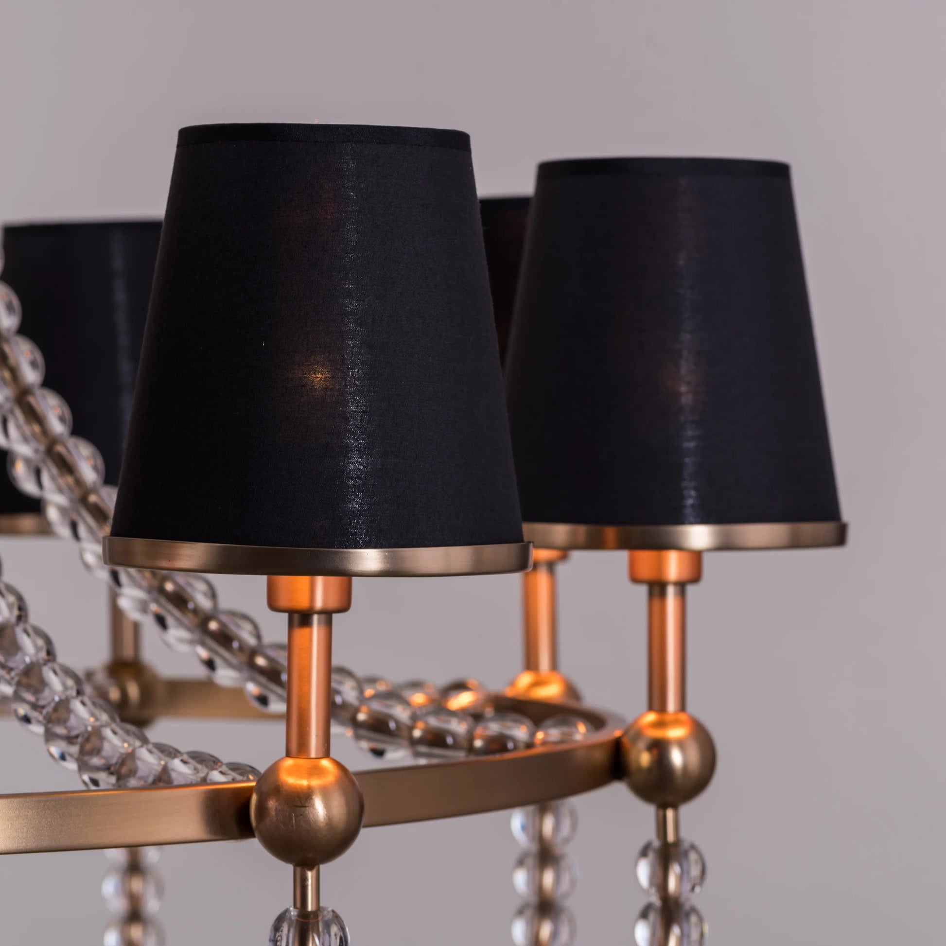 King's Gambit large gold crystal chandelier illuminating a grand entryway