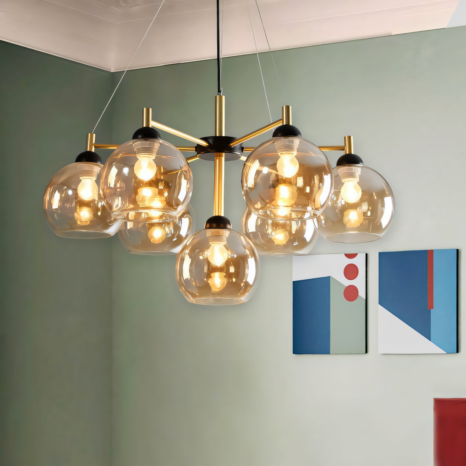 This hanging light boasts a modern design: a gold metal frame with black accents holding 7 amber glass globes (LED).