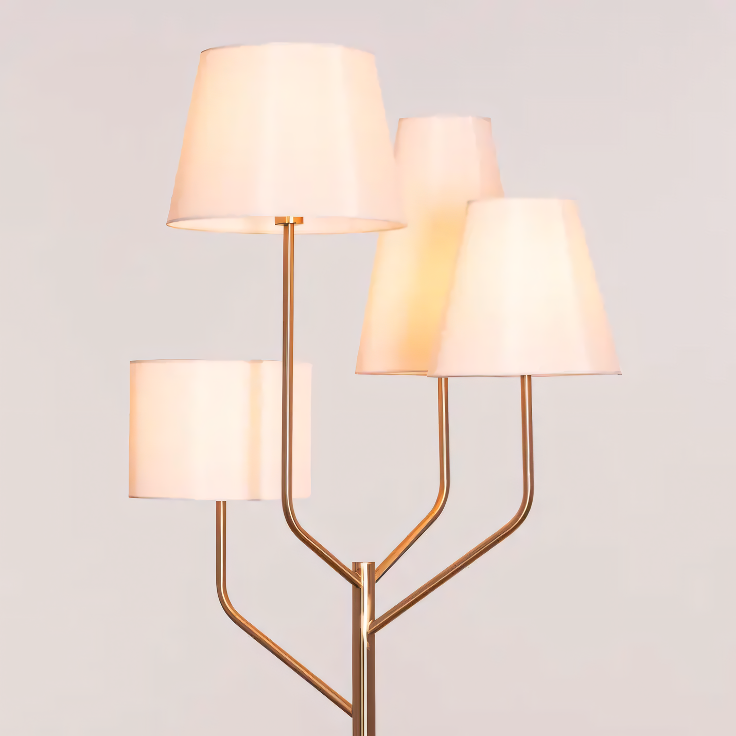 Cozy bedroom illuminated by gold and beige floor lamp