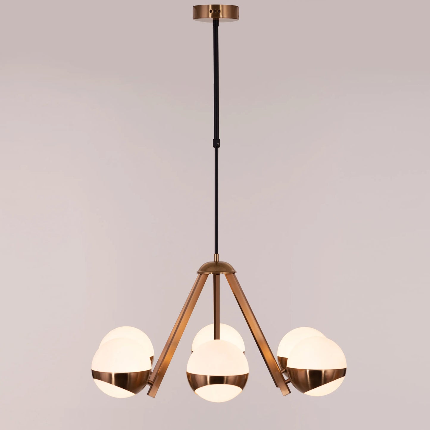 Prime Time Chandelier suspended in an elegant living room, its concentric gold rings casting a warm, inviting glow that draws the eye upward.