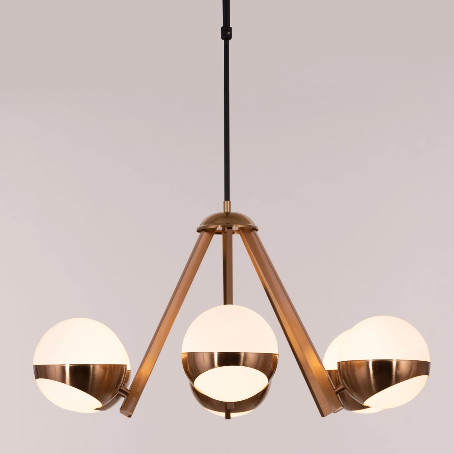 Prime Time Chandelier suspended in an elegant living room, its concentric gold rings casting a warm, inviting glow that draws the eye upward.