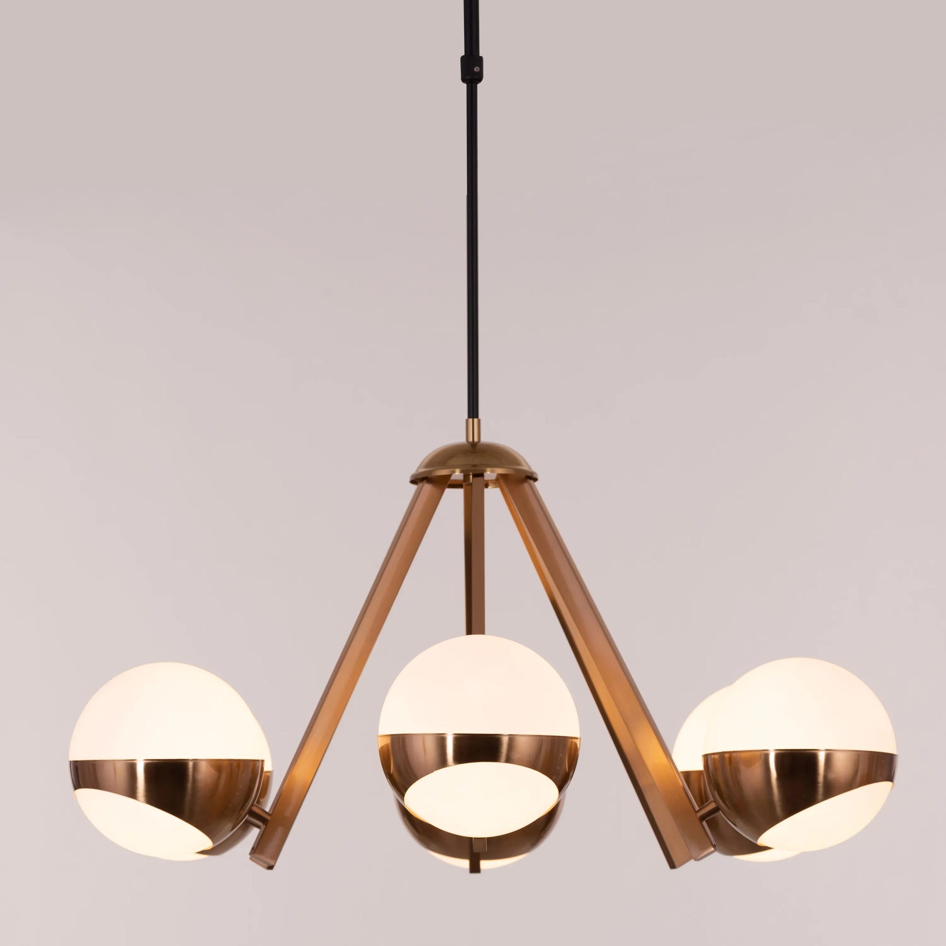 Prime Time Chandelier suspended in an elegant living room, its concentric gold rings casting a warm, inviting glow that draws the eye upward.