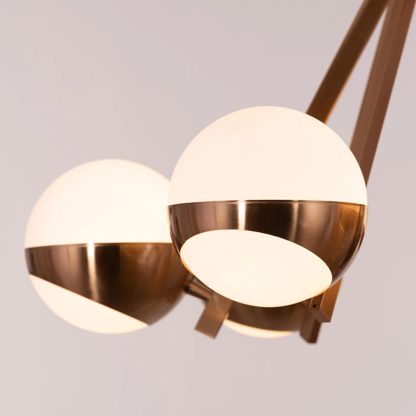 Prime Time Chandelier suspended in an elegant living room, its concentric gold rings casting a warm, inviting glow that draws the eye upward.