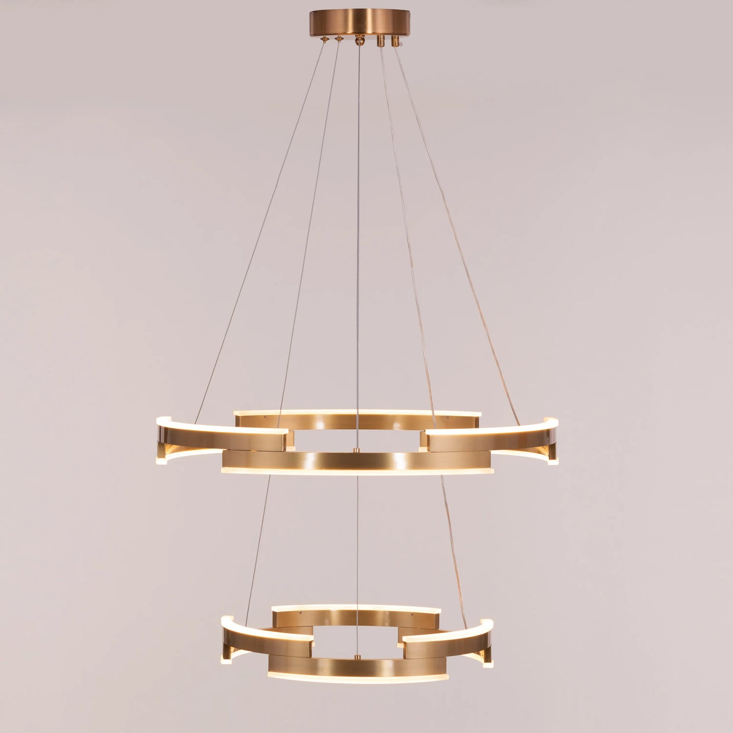 Bring A Friend medium gold chandelier with dimmable LED lights illuminating a modern dining room